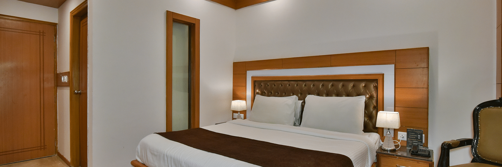 A large bed in Luxury Room Without Balcony at DLS Highland Resort and Spa, Mussoorie.